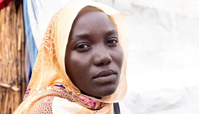 Someya Sudan Someya, wearing a yellow headscarf, looks at the camera